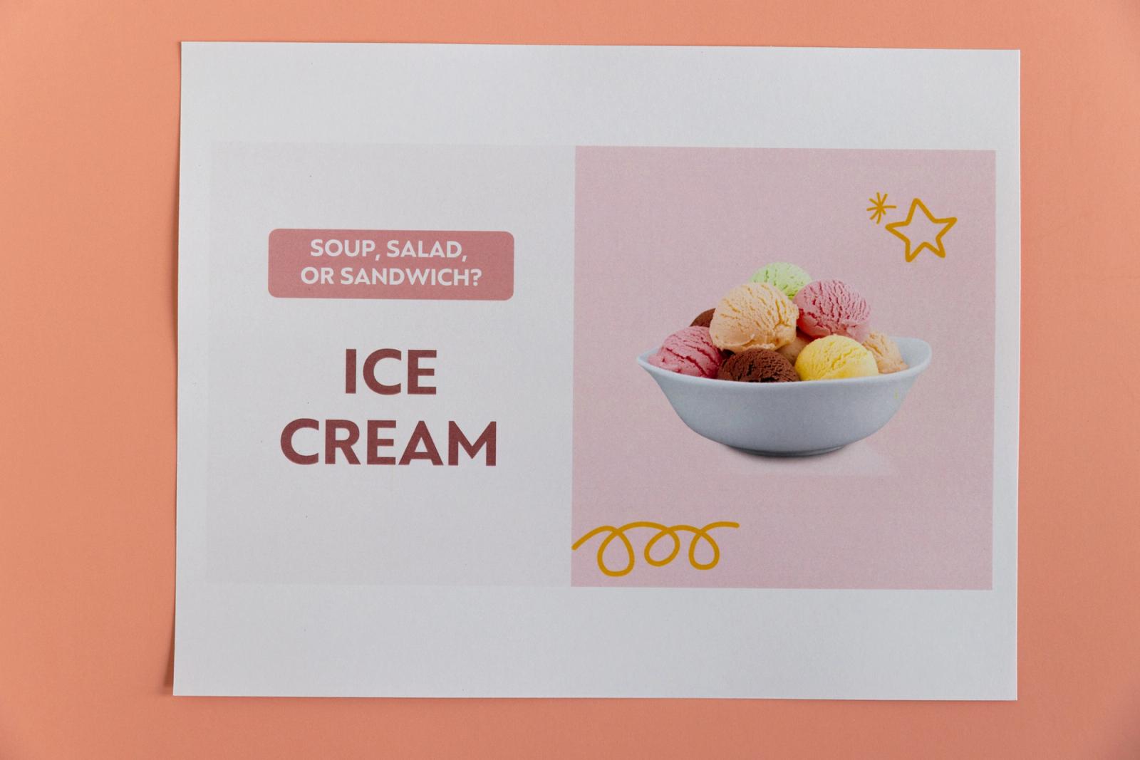 Piece of paper with a picture of ice cream and "soup, salad, or sandwich?" lays on a peach background.