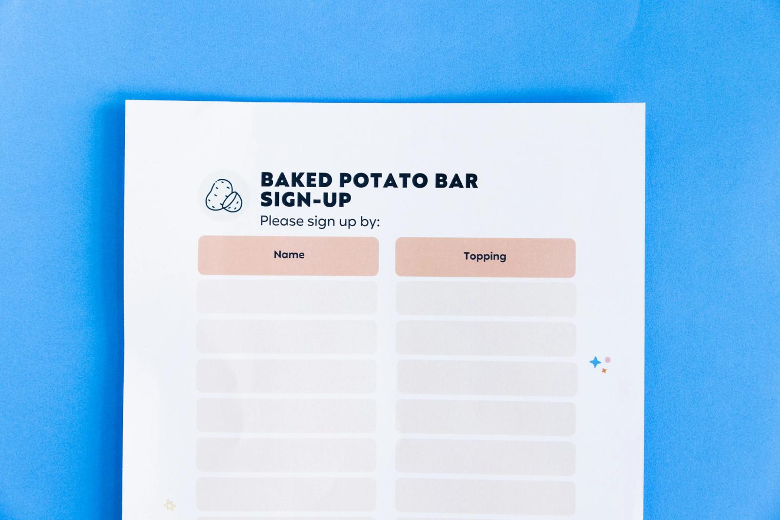 A poster that says "baked potato bar sign-up" lays on a blue background.