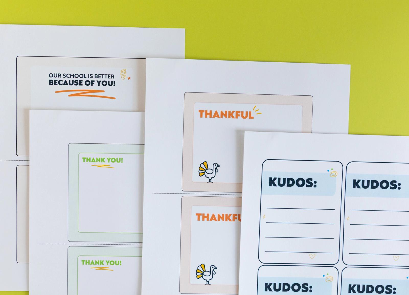 Four sheets of paper with postcard notes on them lay on a light green background.