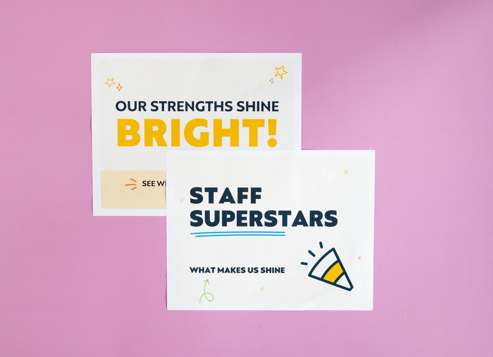 Sheets of paper that say "your strengths shine bright" and "staff superstars" lay on a pink background.