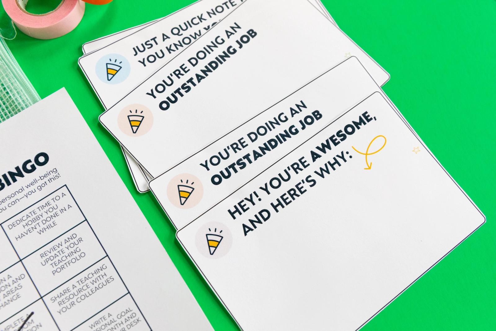 Close up of blank notecards that have positive notes written on them on a bright green background.