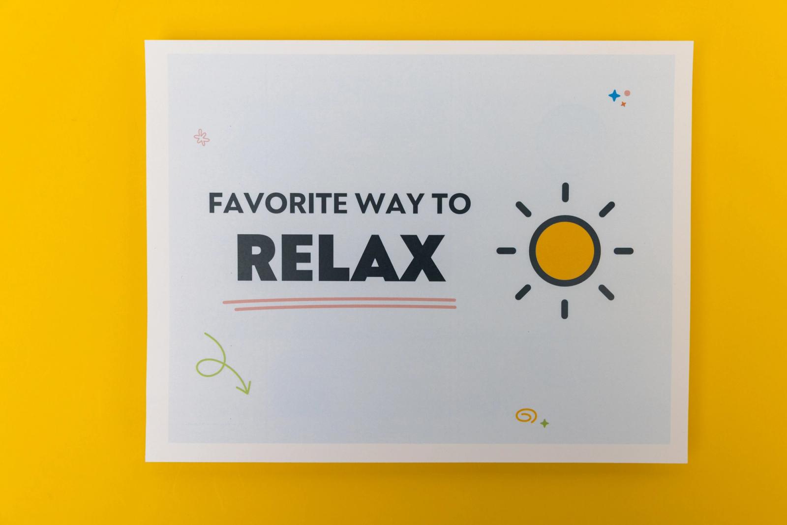 A piece of paper that says "favorite way to relax" lays on a yellow background.