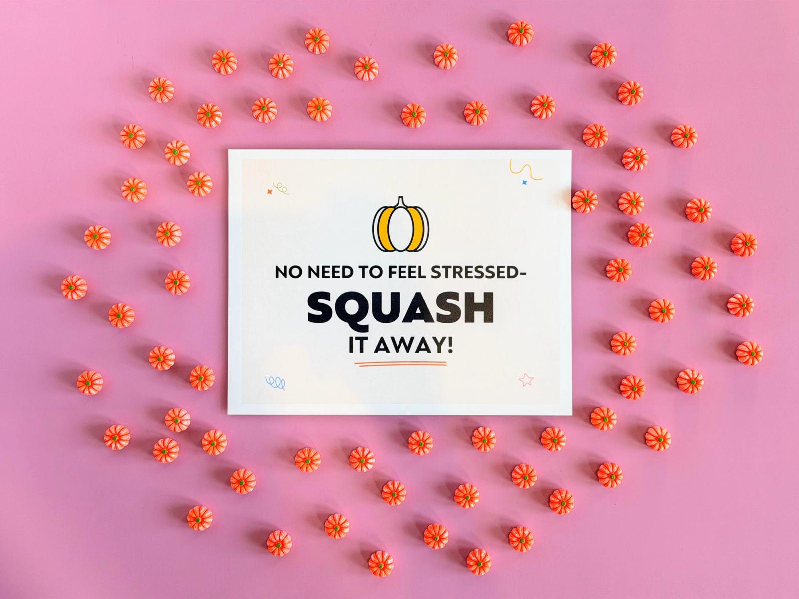 “Squash it away” Halloween teacher morale booster sign with a pumpkin icon, ringed by dozens of pumpkin candies