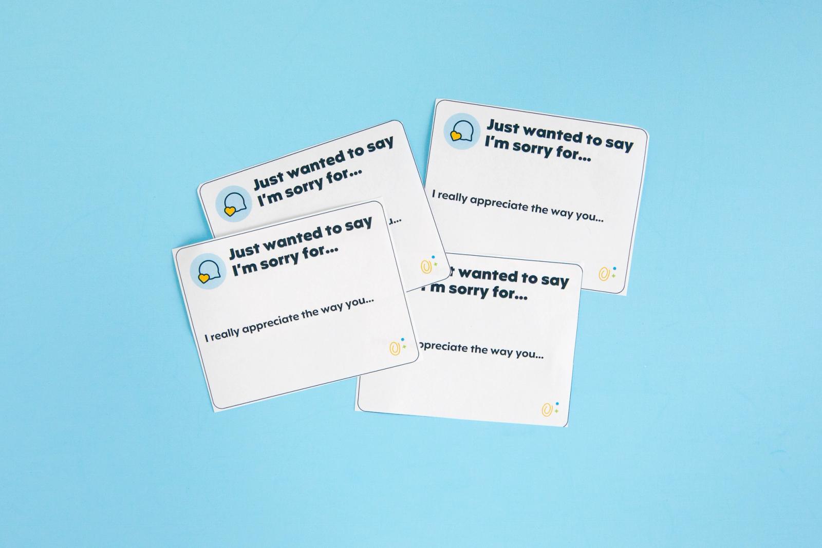 Four small notecards lay on a light blue background.