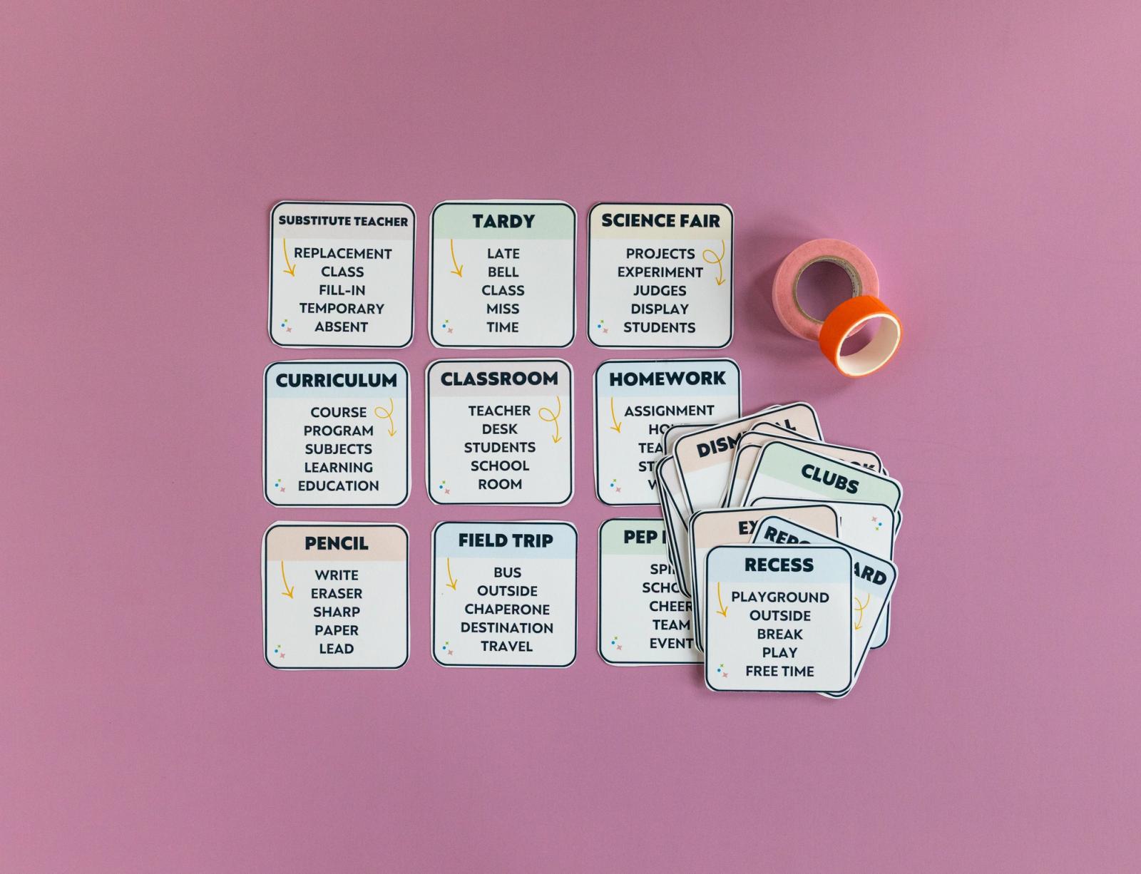 Six small cards lay on a light purple background with a stack of cards next to them.