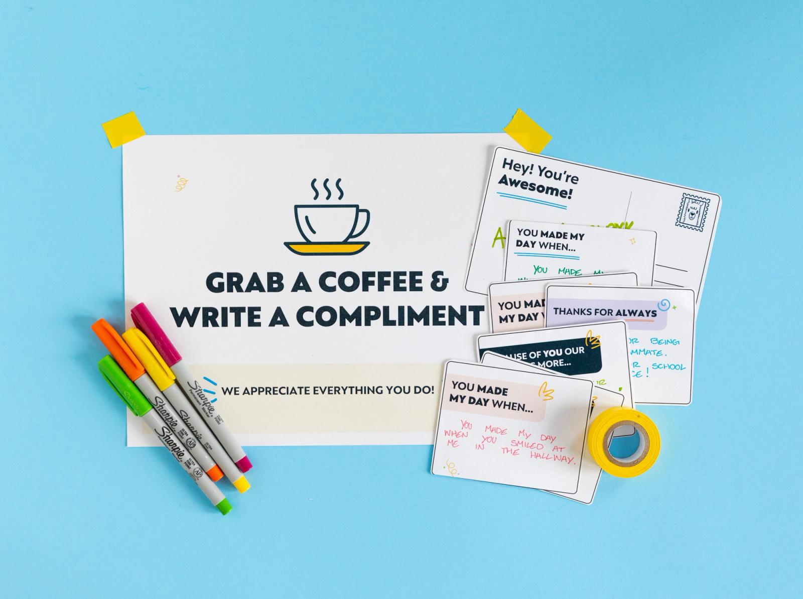 A poster as well as notecards with written messages lay on a light blue background. Colorful pens lay next to the poster.