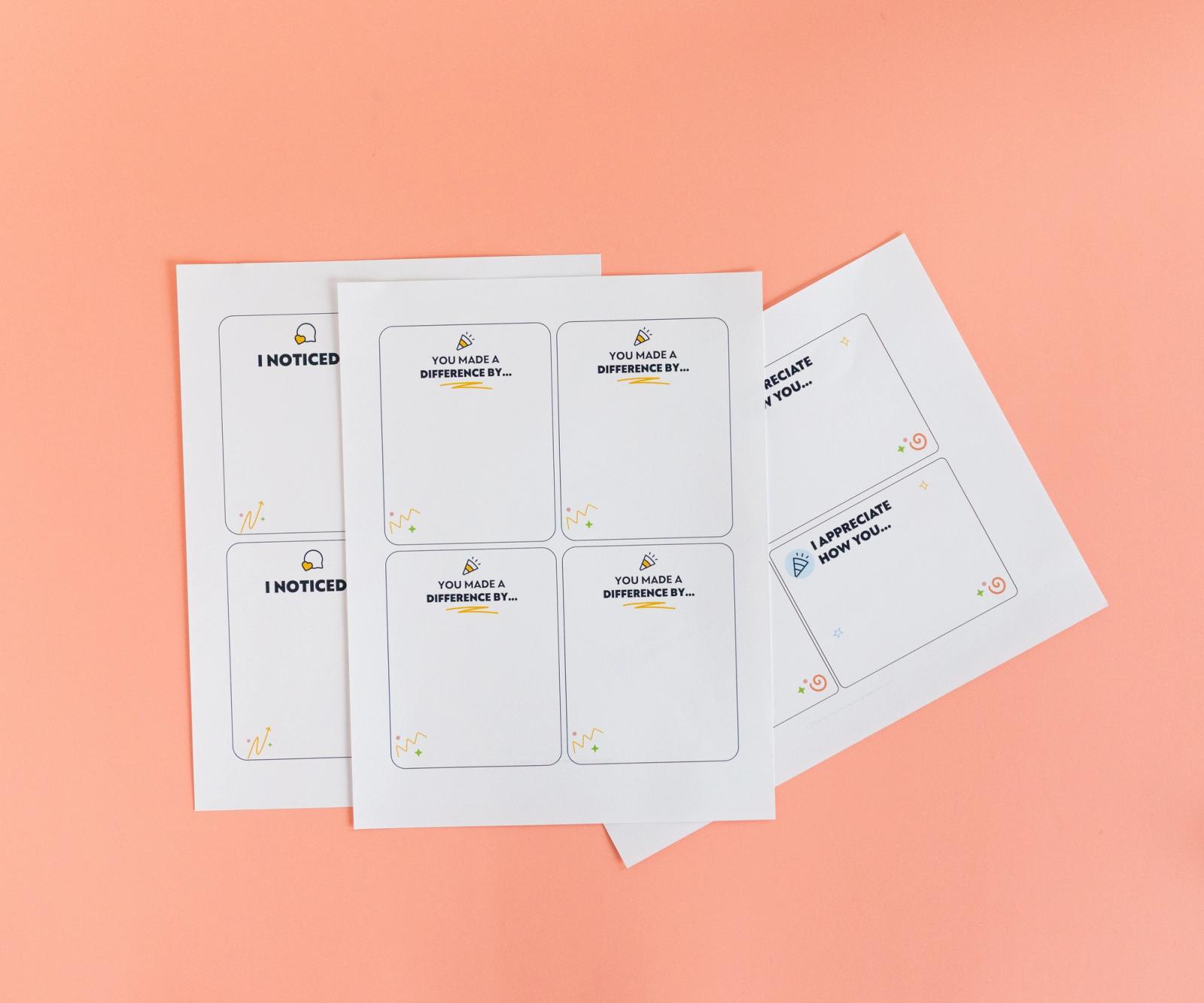 Sheets of paper with notecards on them lay on a salmon background.