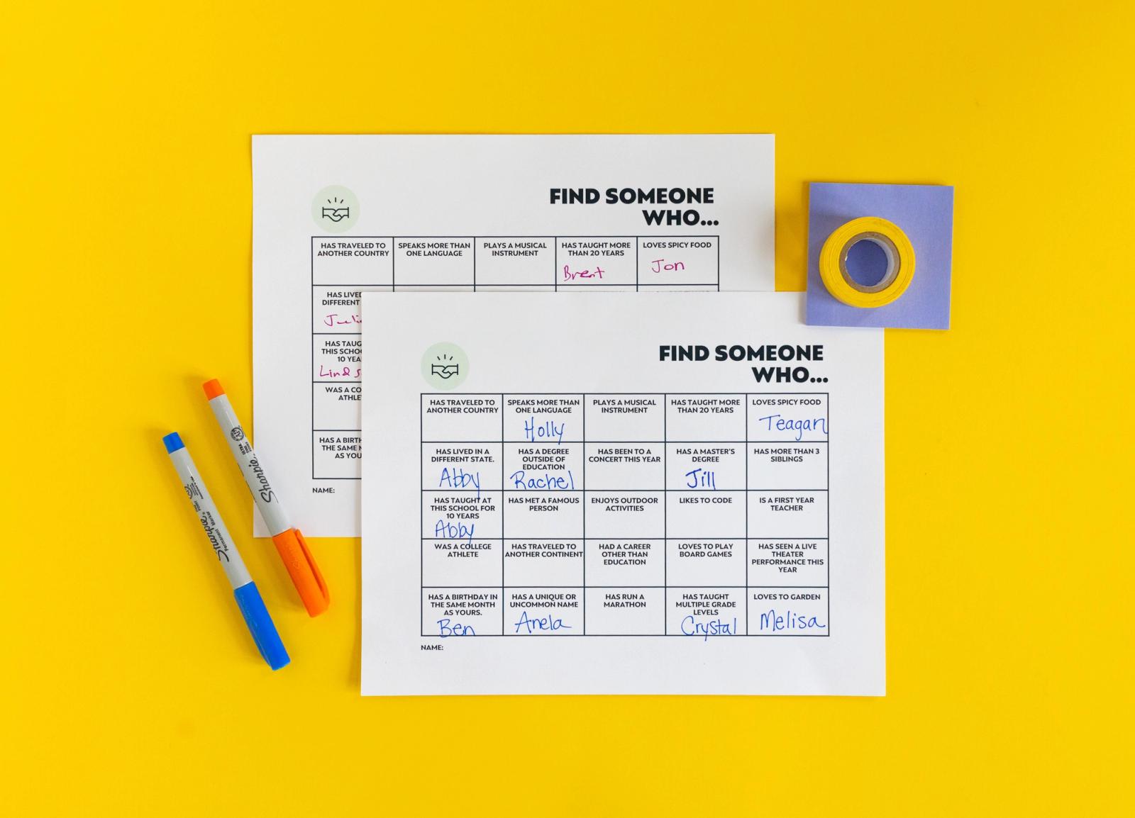 Two sheets with grids on them and "find someone who" lay on a yellow background. Pens and school supplies lay around them.