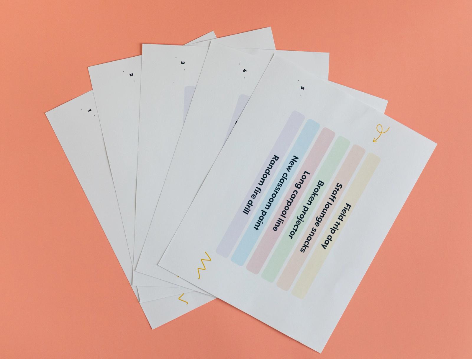 Sheets of paper lay fanned out on an orange background.