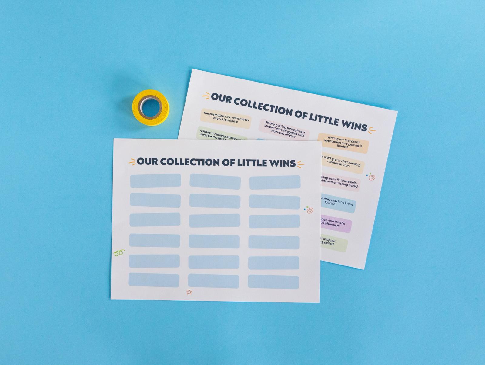 Two sheets of paper that say "our collection of little wins" and a roll of tape lay on a light blue background.