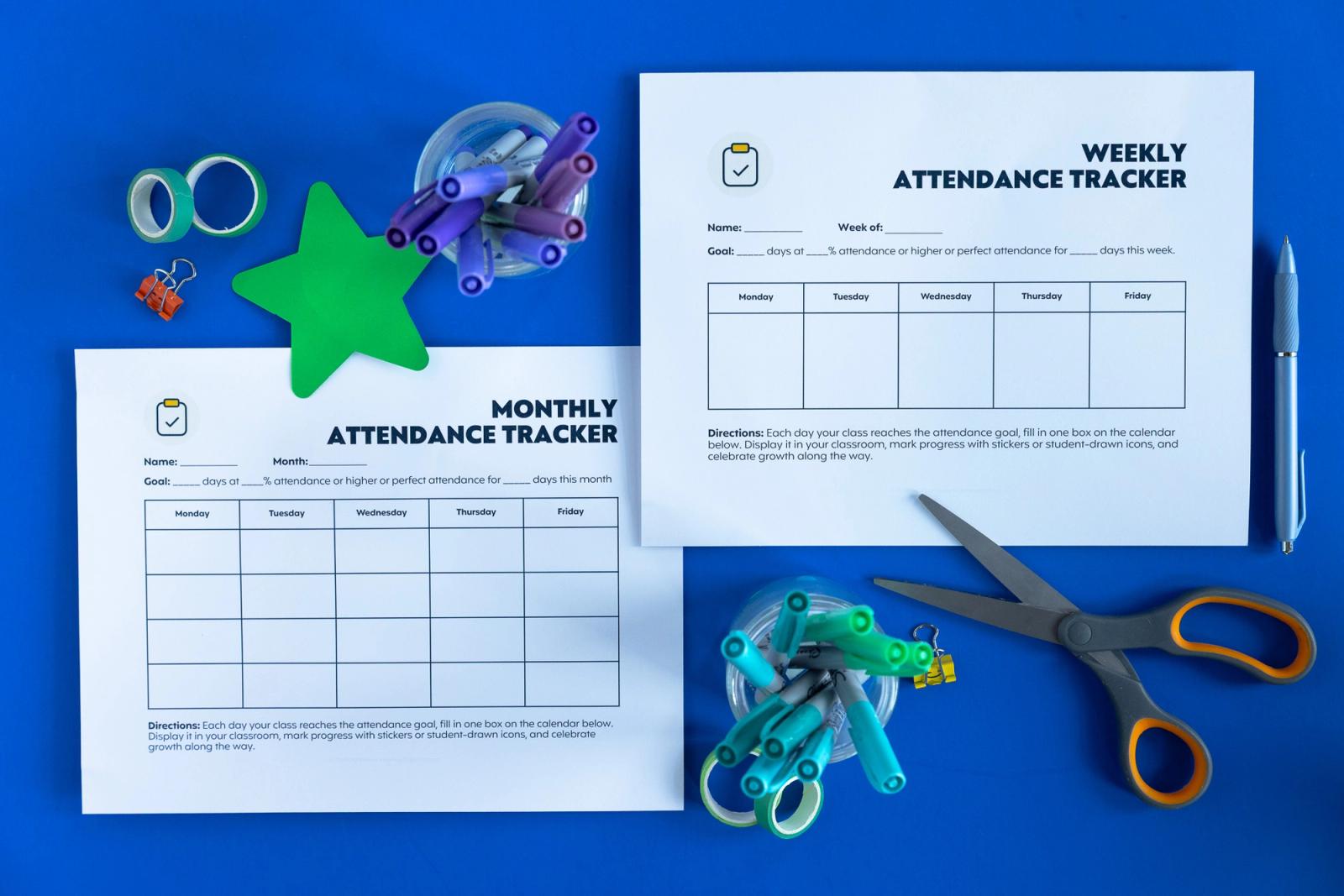 Two sheets of paper lay on a blue background. Scattered around them are school supplies.