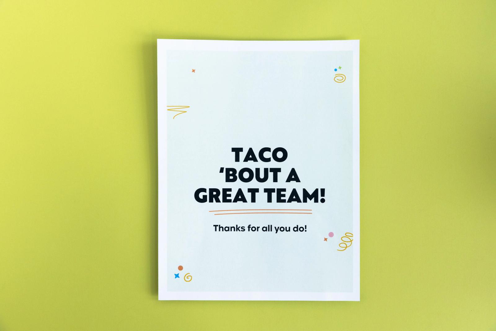 A paper that says "taco 'bout a great team" lays on a light green background.