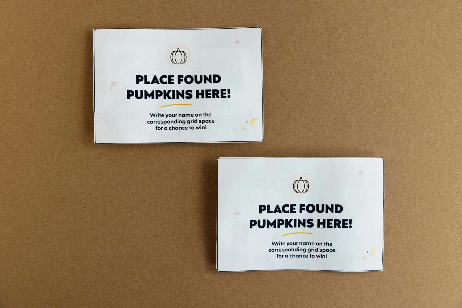 Two pieces of paper that say "place found pumpkins here" lay on a brown background.
