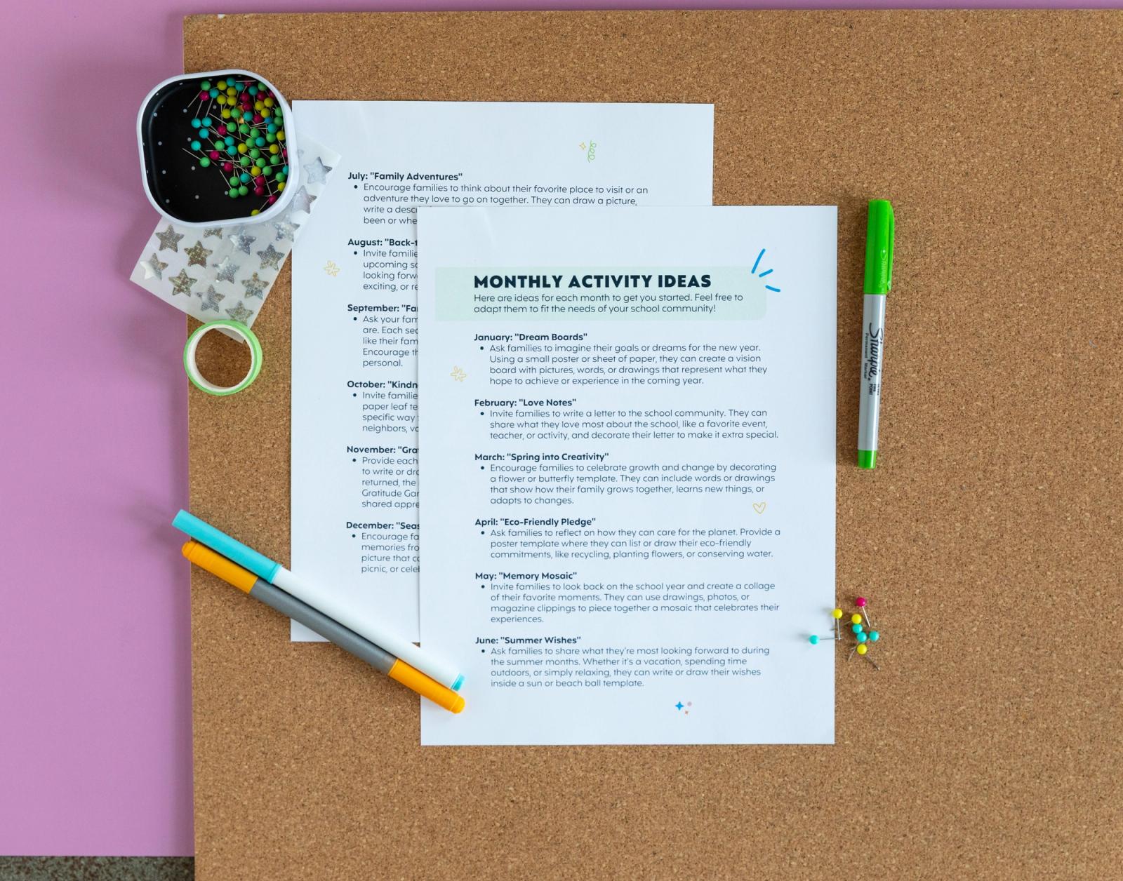 A bulletin board sits on a light purple background. Two sheets of paper, pens, stickers, and pins lay on the bulletin board.