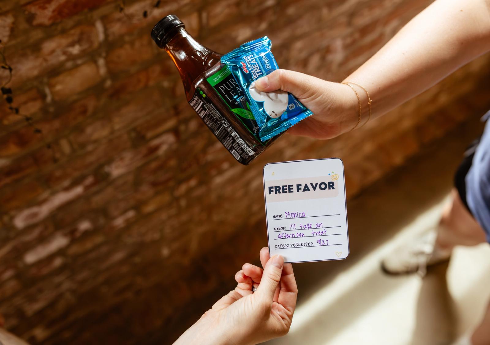 A hand reaches in from the side and holds a coupon that says free favor. Another hand reaches in with a drink bottle and small snack.