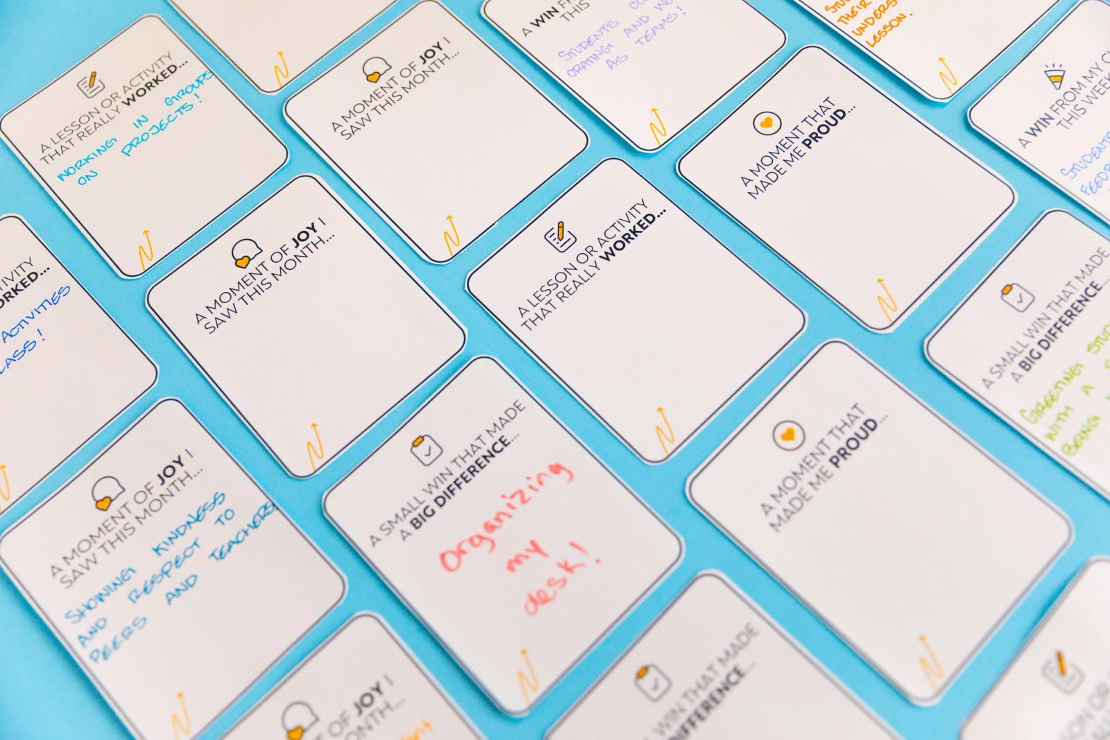 Closeup of notecards lay diagonally on a light blue background.