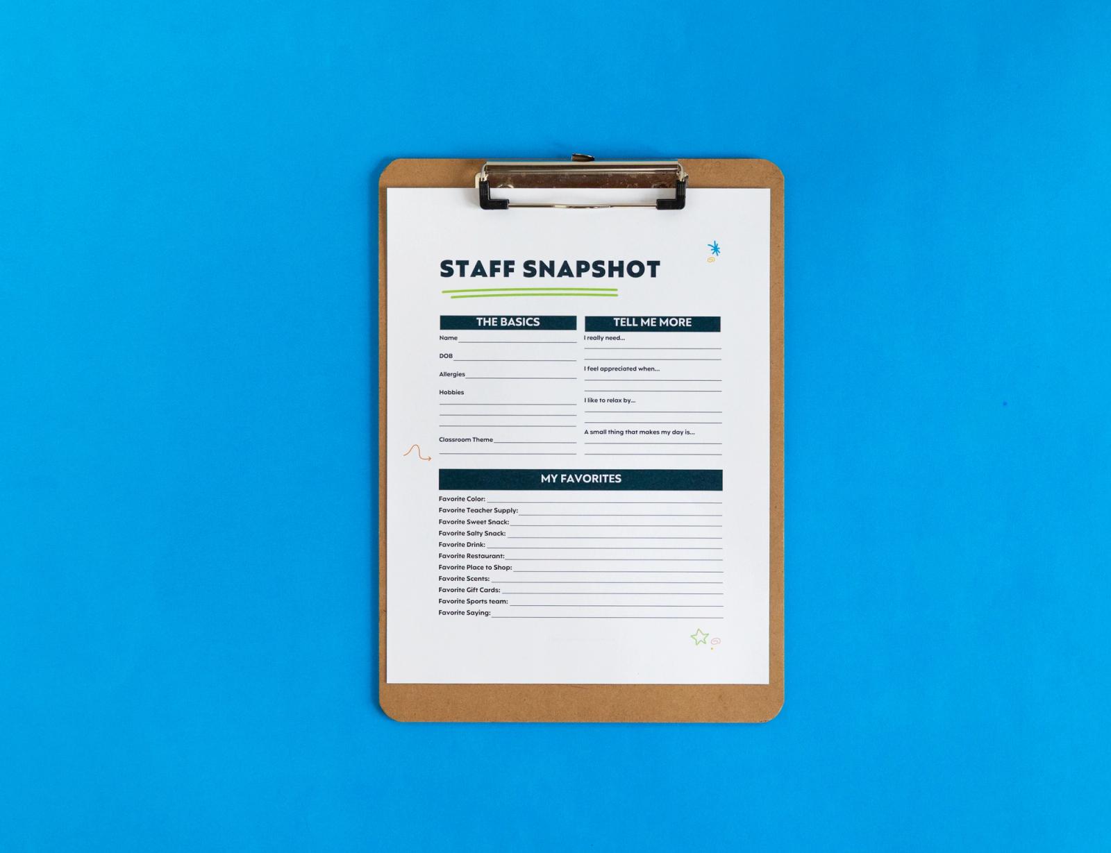 A sheet of paper that says "staff snapshot" lays on a blue background.