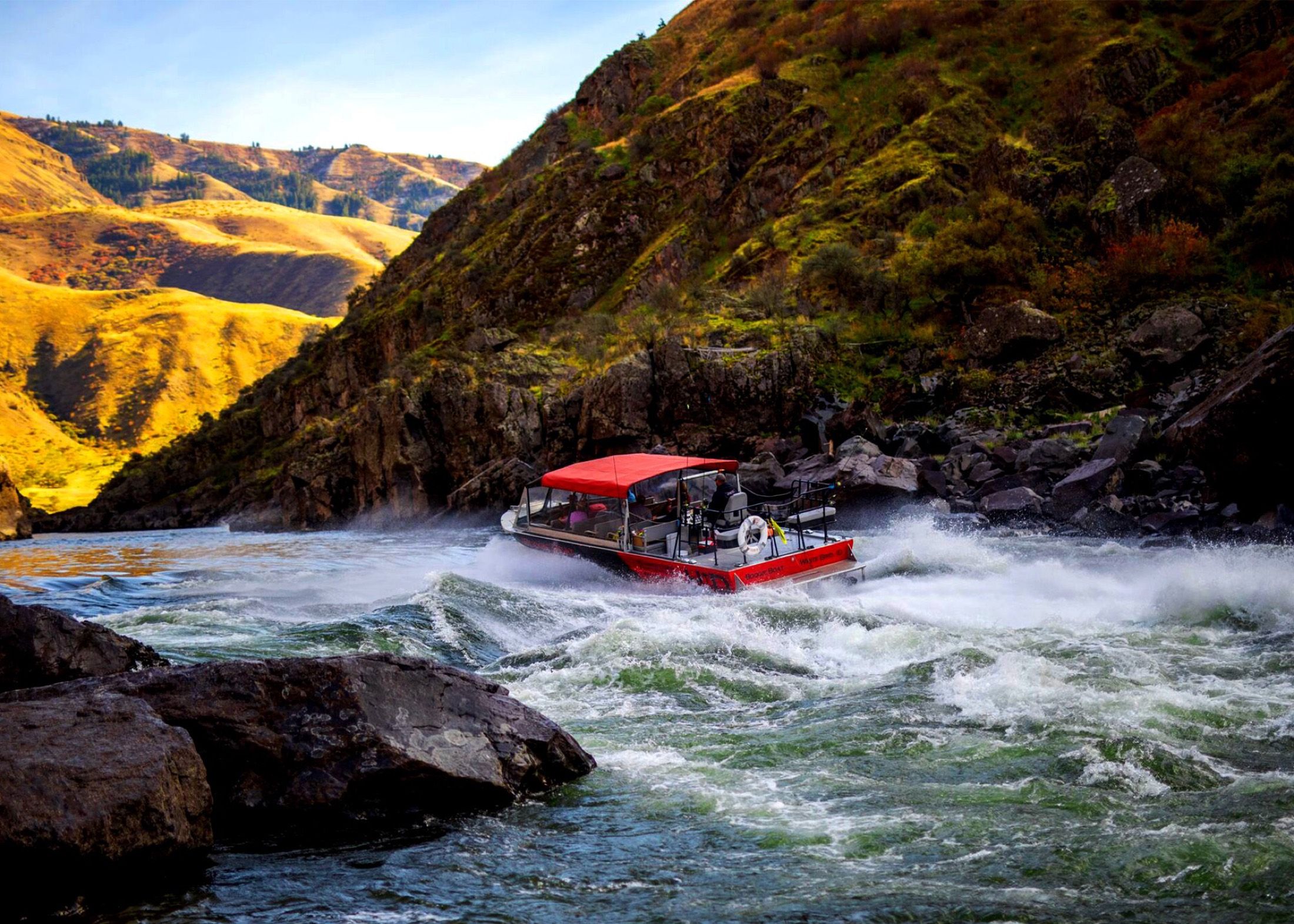 Hammer Down's red jet boat blasting through whitewater in Hells Canyon, Idaho