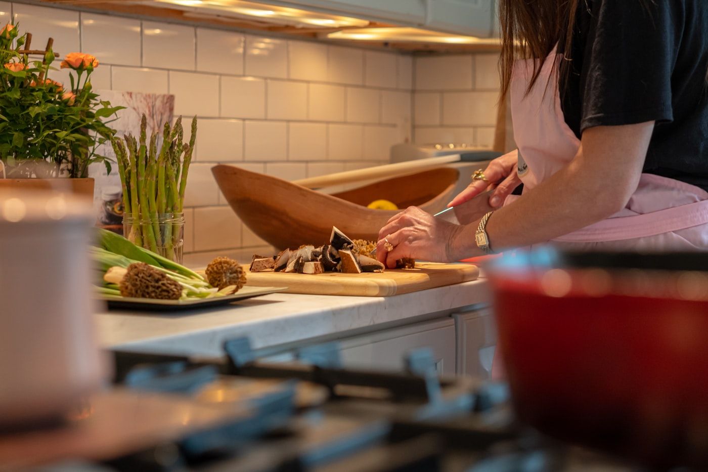 A home cook quickly assembling a simple dinner on a kitchen bench on a busy weeknight, photo by Douglas Fehr on Unsplash