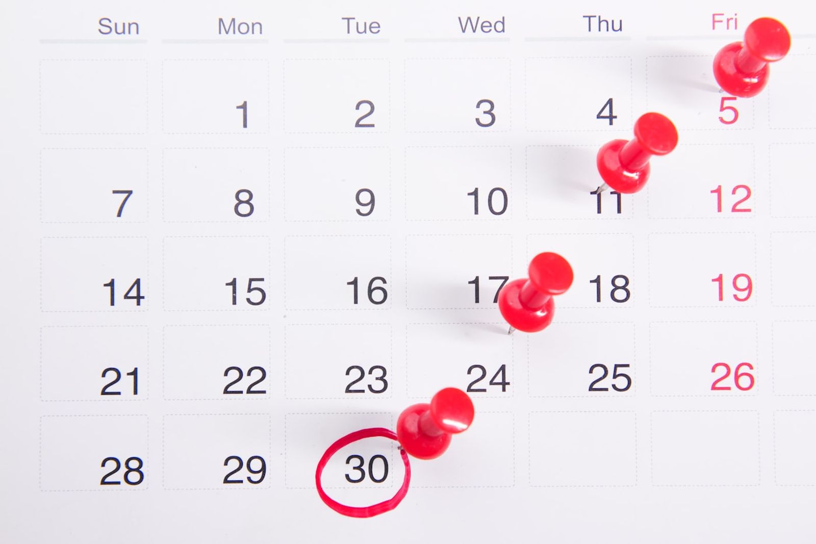 A kitchen calendar on a wall with Monday circled, next to a half finished cup of coffee on a bench, photo by Towfiqu barbhuiya on Unsplash