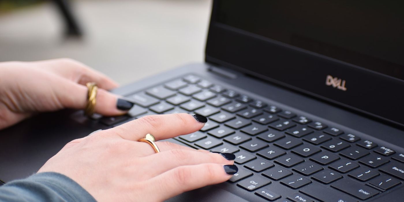 Business owner typing on a laptop while drafting an AI prompt