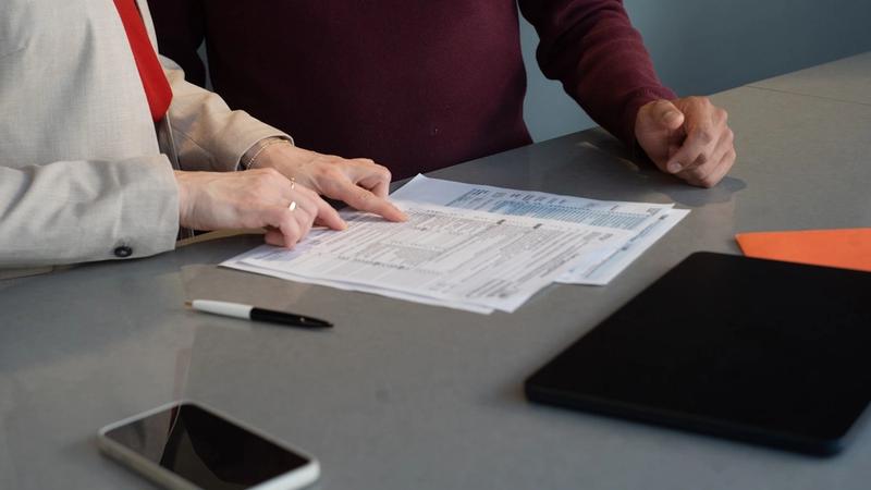 Two people reviewing documents together at a table, photo by Olena Kholina on Unsplash