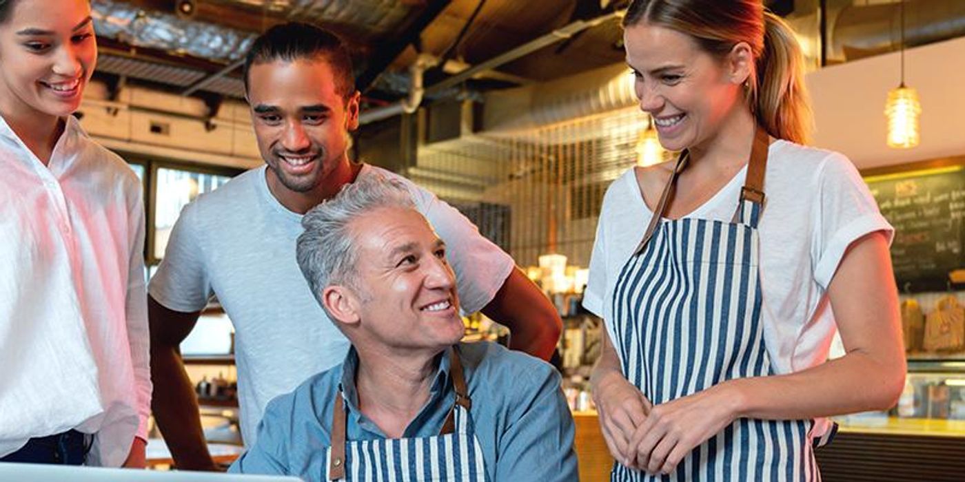 Business owner reviewing AI adoption data on a laptop in a modern Australian office