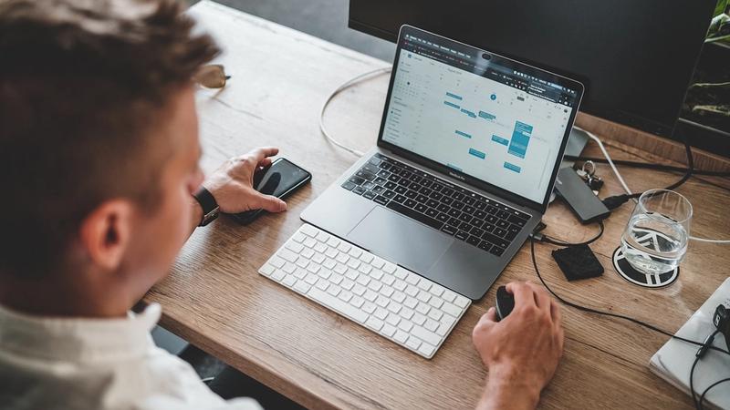 Small business owner working at a laptop — using AI to automate operational admin