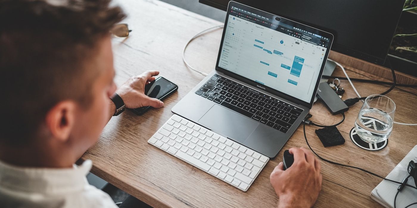 Small business owner working at a laptop — using AI to automate operational admin