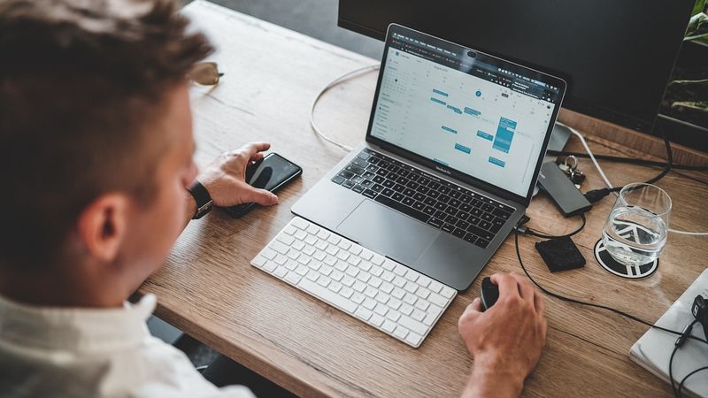 Small business owner working at a laptop — using AI to automate operational admin