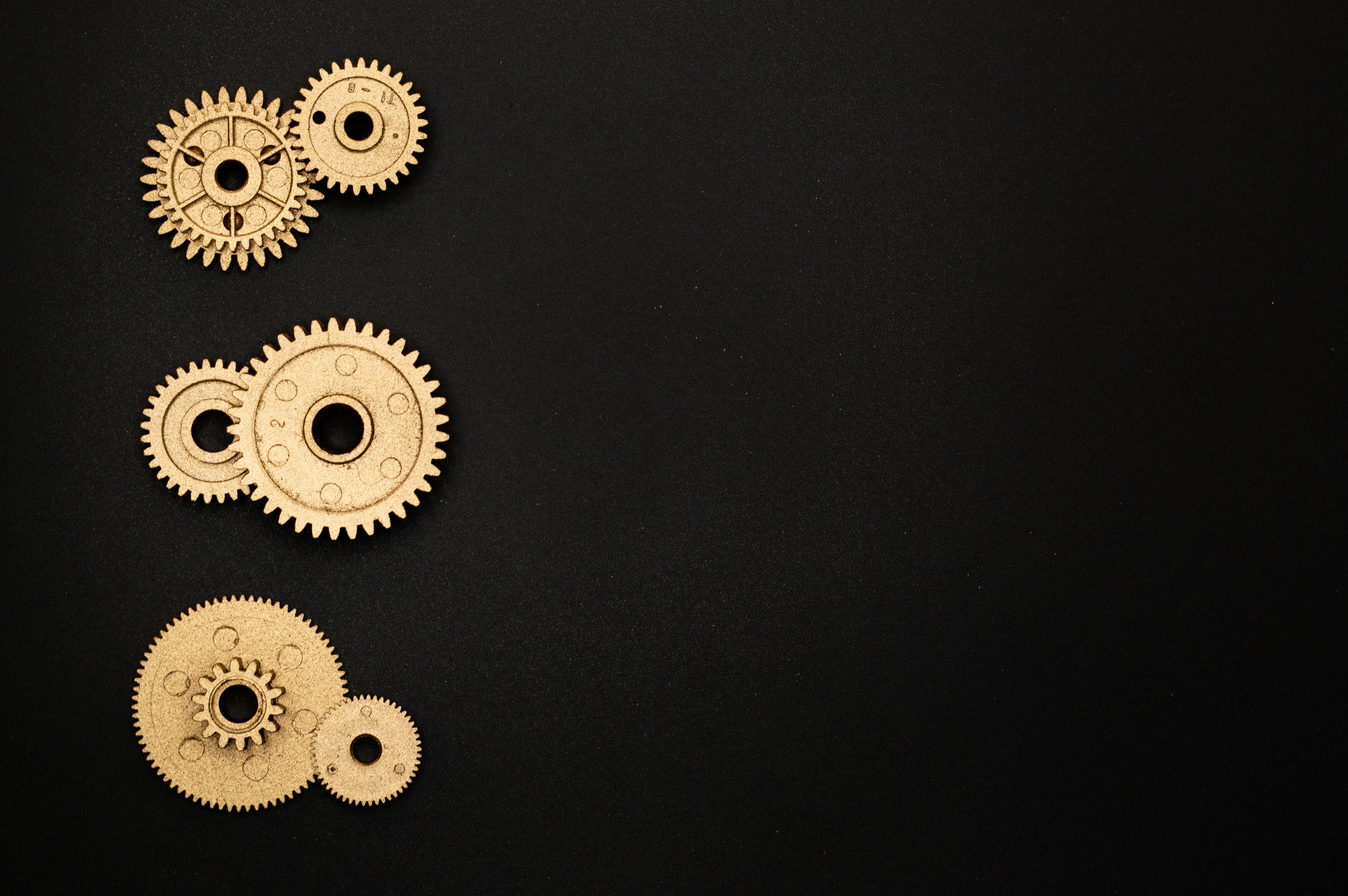 Brass clockwork gears arranged on a black surface