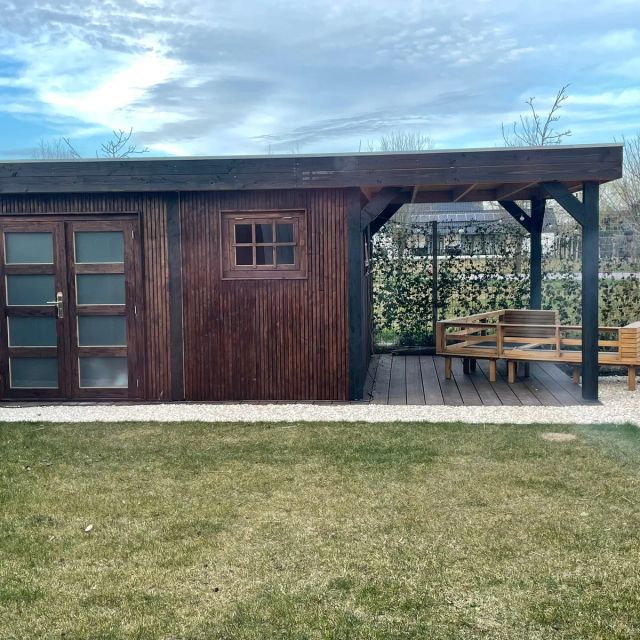 Vuren tuinhuis met overkapping in donkere tinten, behandeld met Osmo Natuurlijke Olie-Beits 727, Pallisander