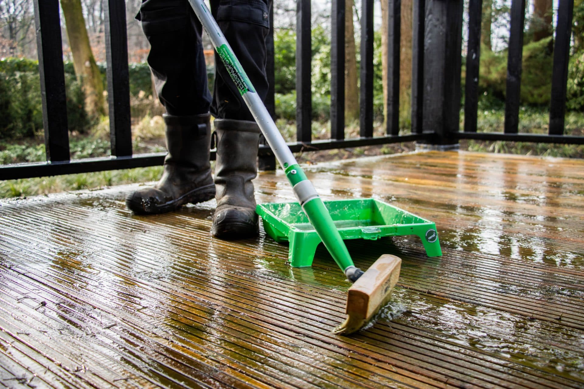 Person is coating the decking