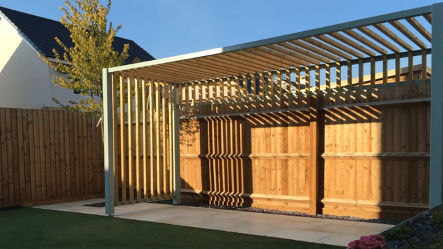 Houten pergola met lamellen in een tuin
