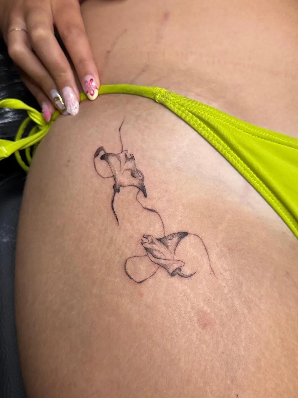 Delicate fine line stingray tattoo on hip done at GG Tattoo Budva, a professional studio offering custom tattoo in Budva Montenegro.