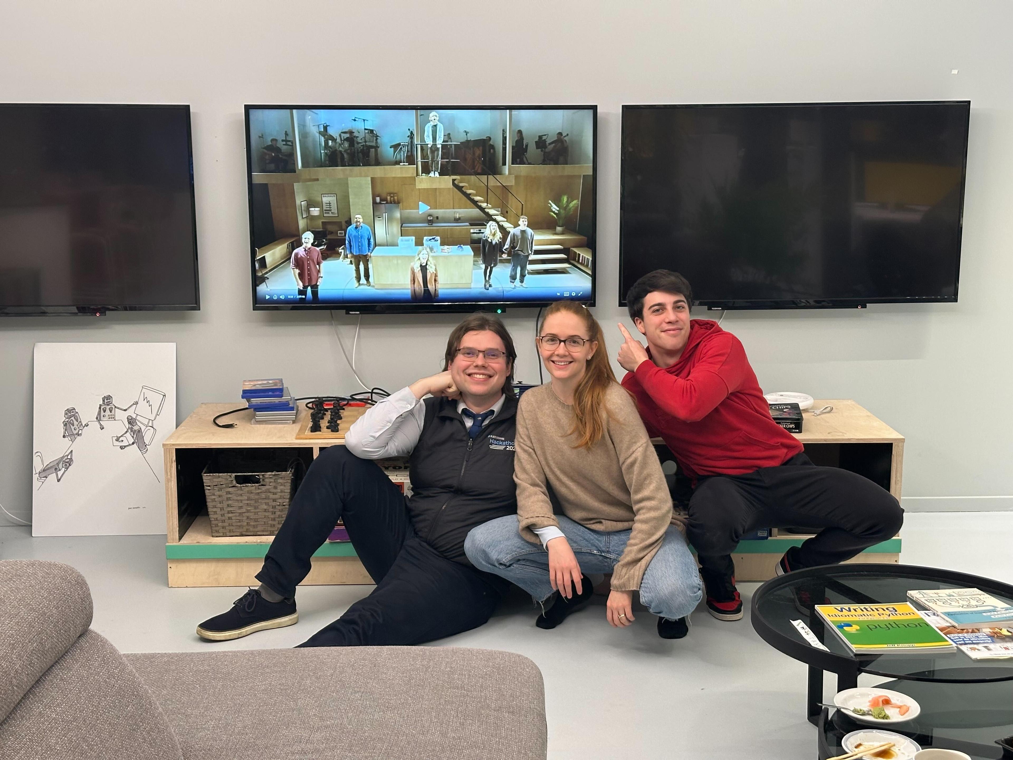 Travis, Leo, and Alessio sitting on the floor in the office