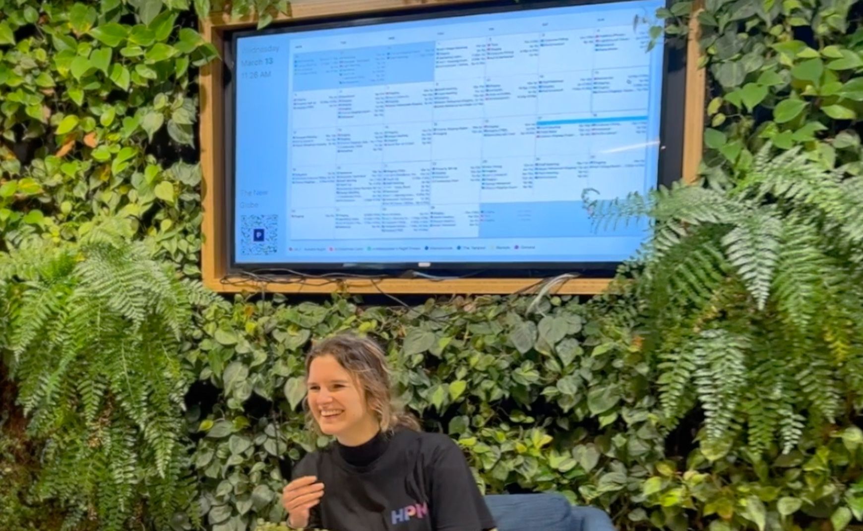 A television displaying Prospero's TV mode with a smiling woman sitting in front