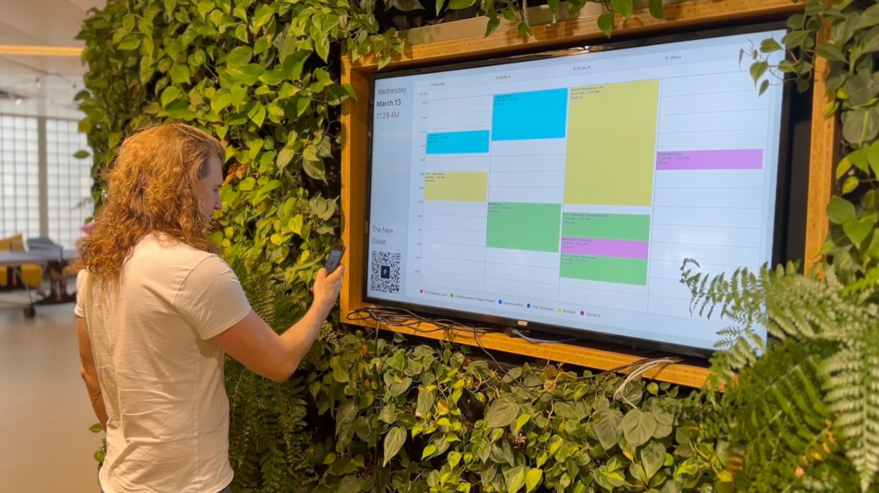 A person scanning the QR code displayed in Prospero's TV mode