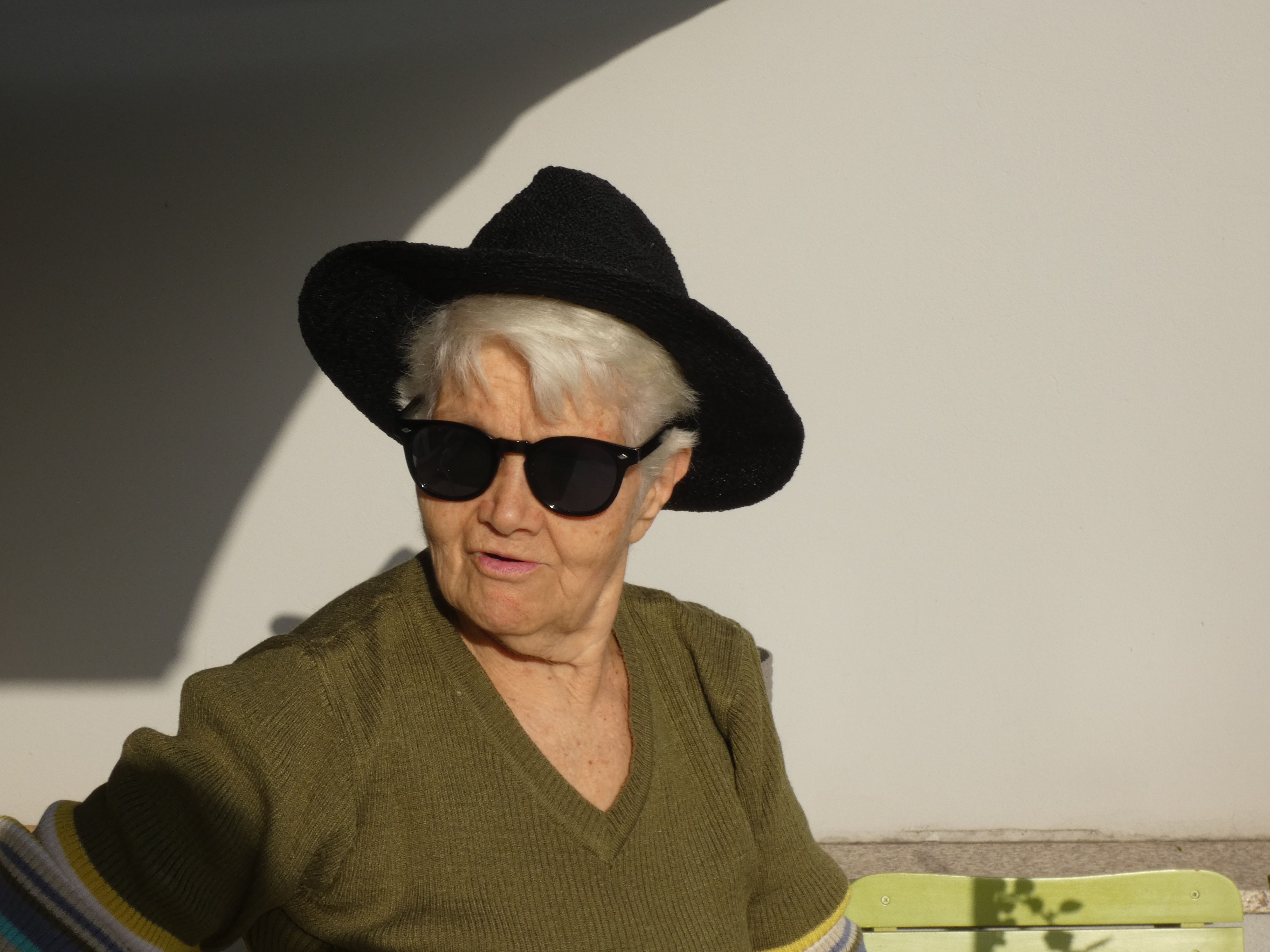 grandma with sunglasses and hat smiling