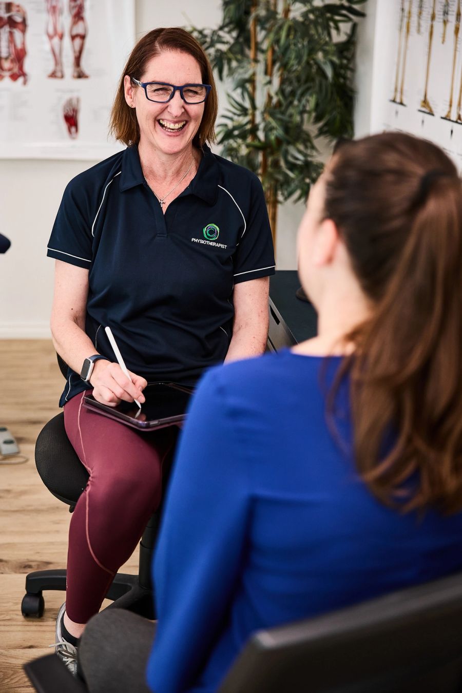 Physiotherapist talking with a patient during a consultation