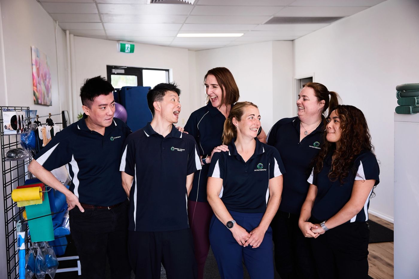 The clinic team standing together in the gym