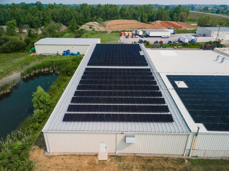 Drone view of Rolite Manufacturing Inc.’s rooftop solar panels installed by Buffalo Solar, showing a commercial solar array designed to reduce energy costs, offset electricity usage, and support sustainable manufacturing operations in New York.