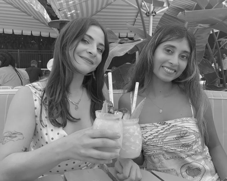 House of Psalm team members enjoying cocktails at outdoor bar with umbrellas