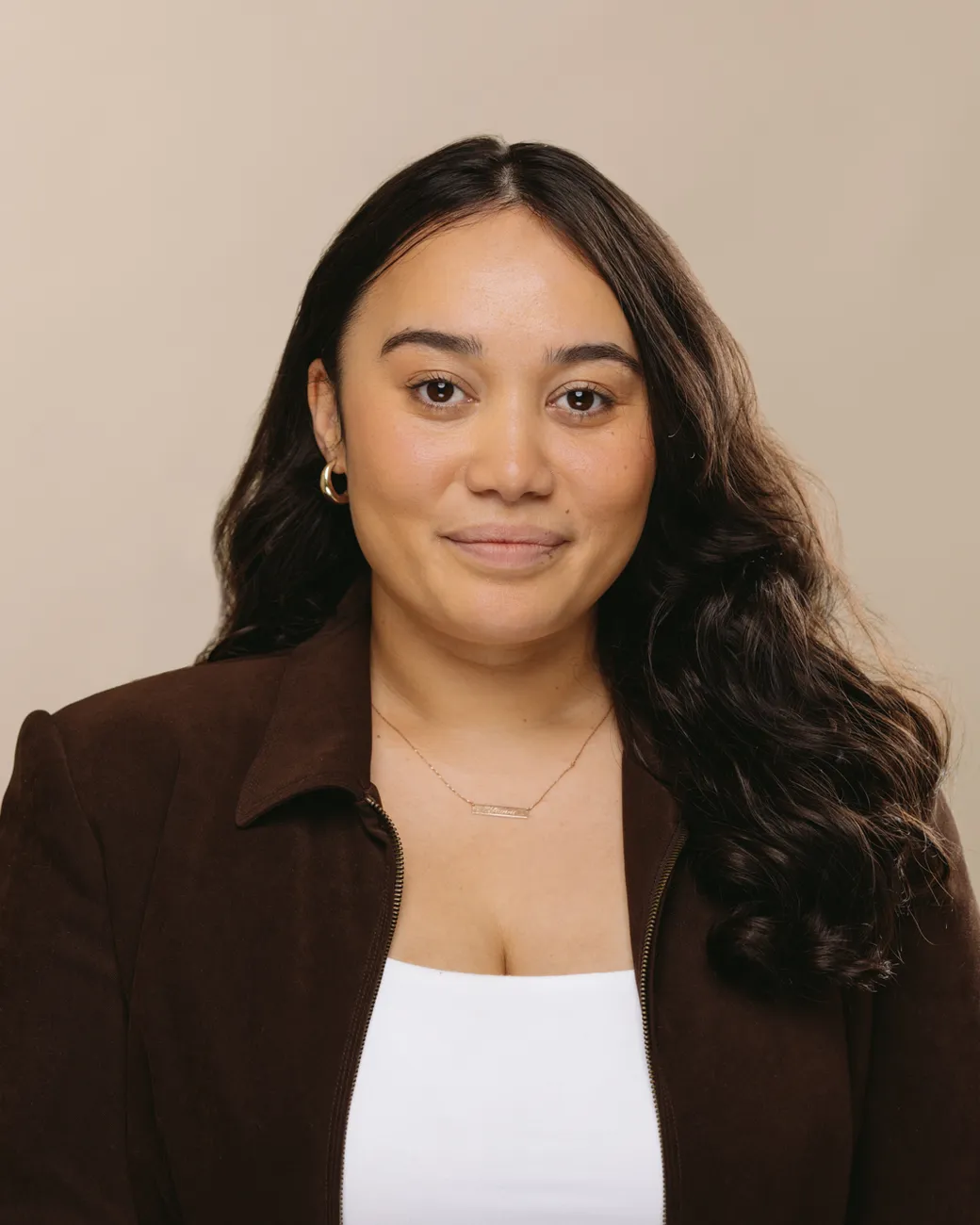 Yhanni Walker Executive Assistant at House of Psalm professional headshot wearing black top and dark brown blazer