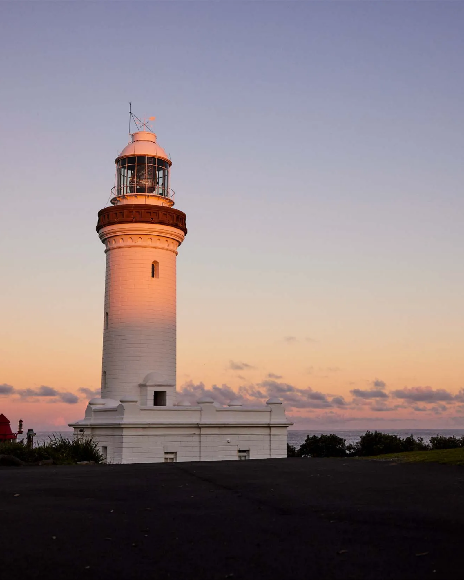 Scenic lighthouse at sunset near Reflections Holidays park, a popular coastal sight to see in New South Wales