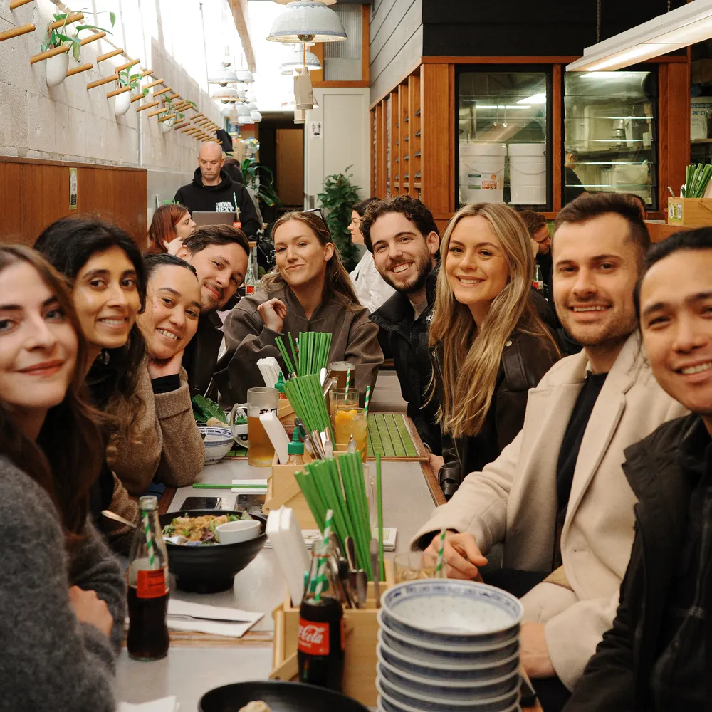 House of Psalm team group lunch at restaurant with bowls, drinks, and long dining table