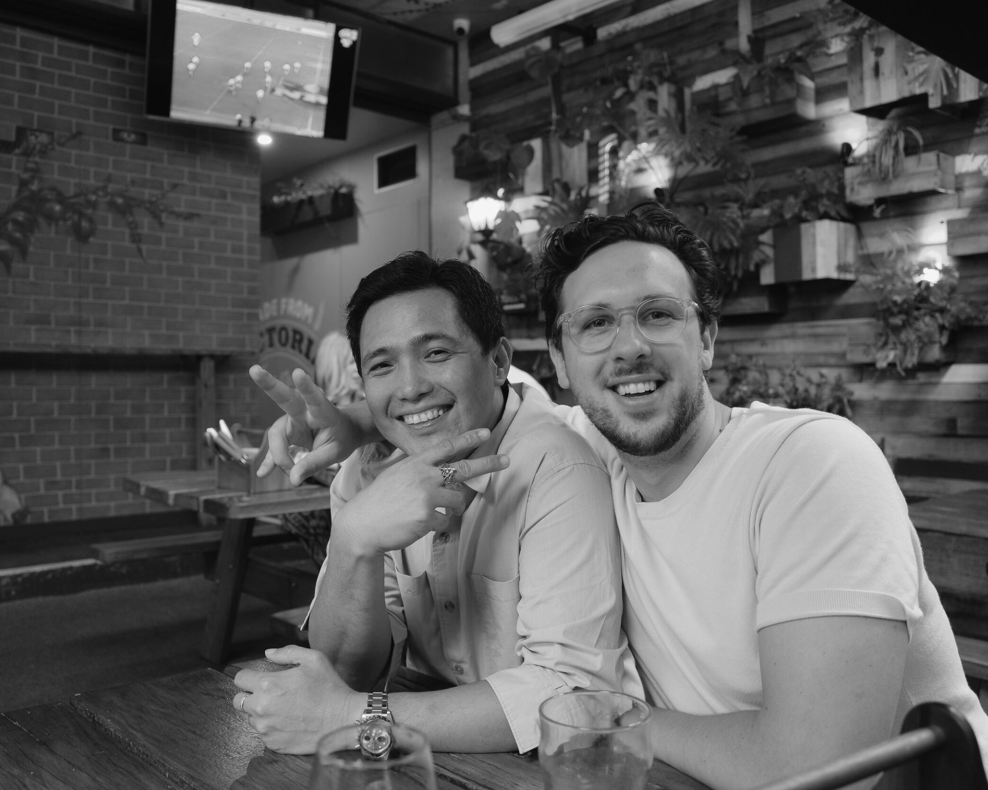 House of Psalm colleagues at bar enjoying drinks and posing together