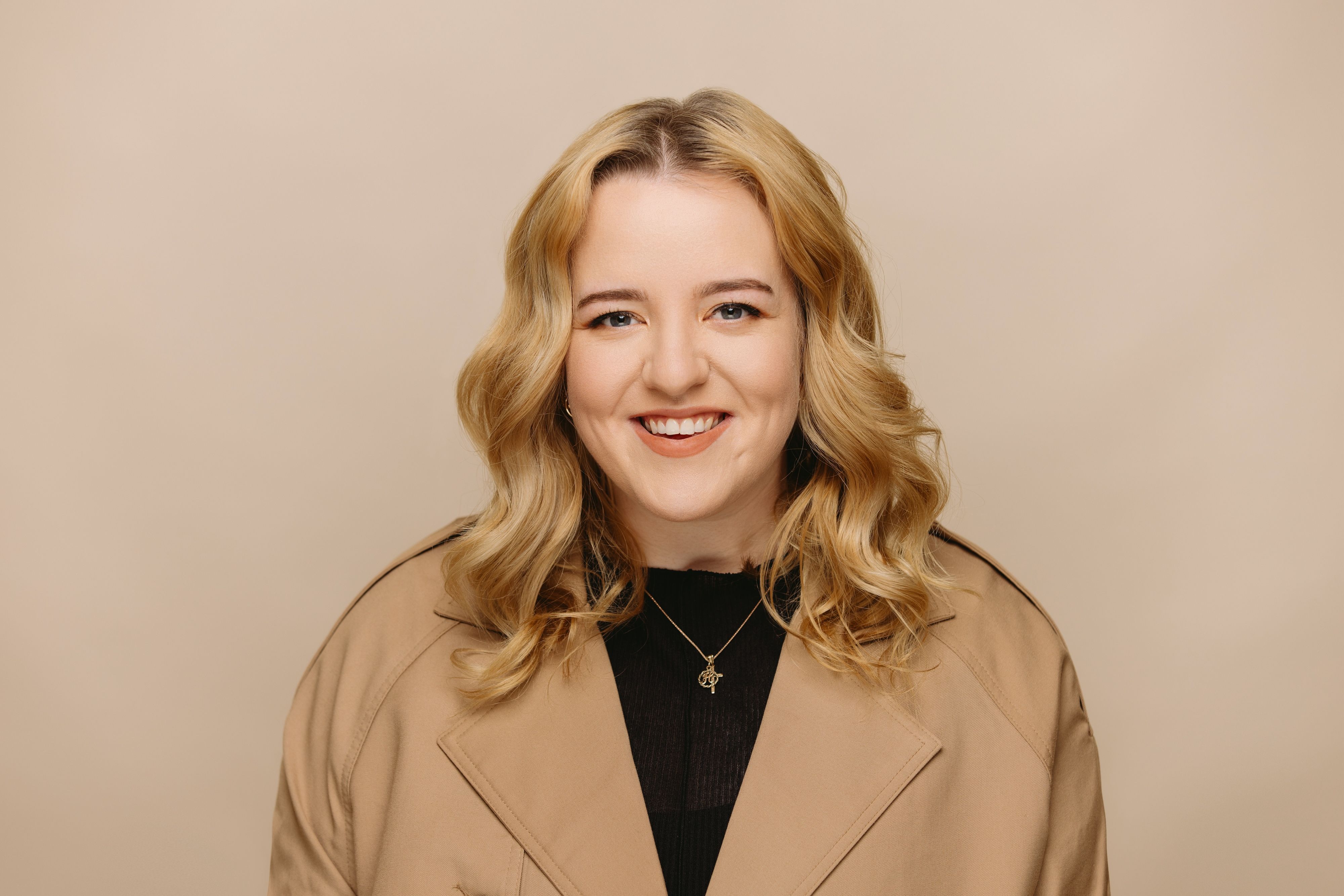 Hannah Cooper Operations Coordinator at House of Psalm professional headshot wearing black top with hands on hip