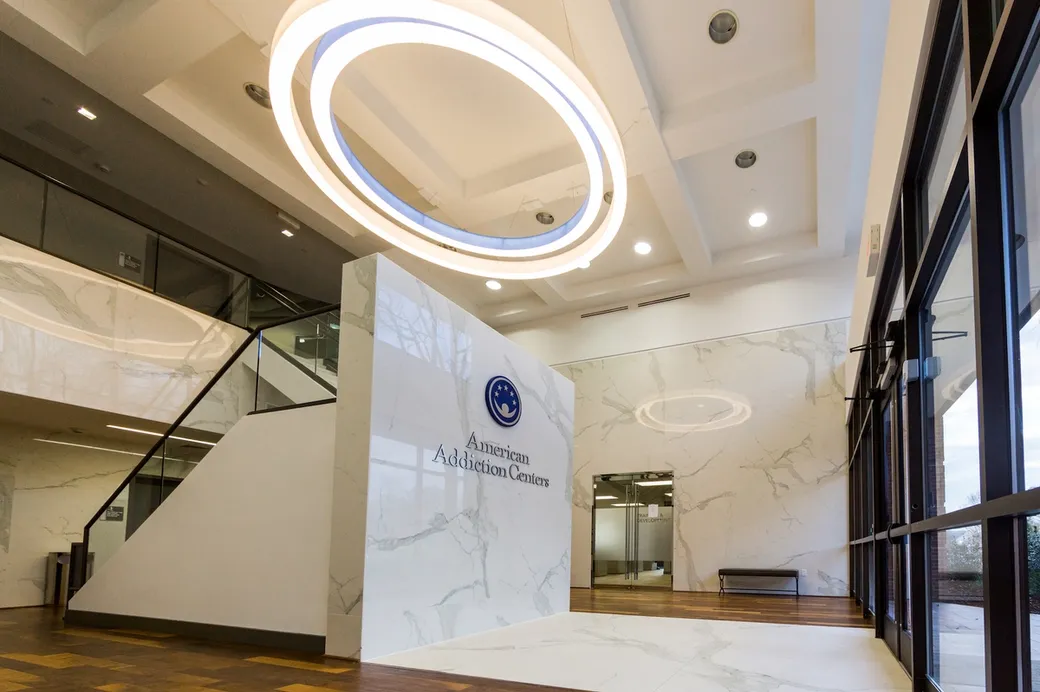 American Addiction Centers modern reception area with marble walls and circular ceiling lights