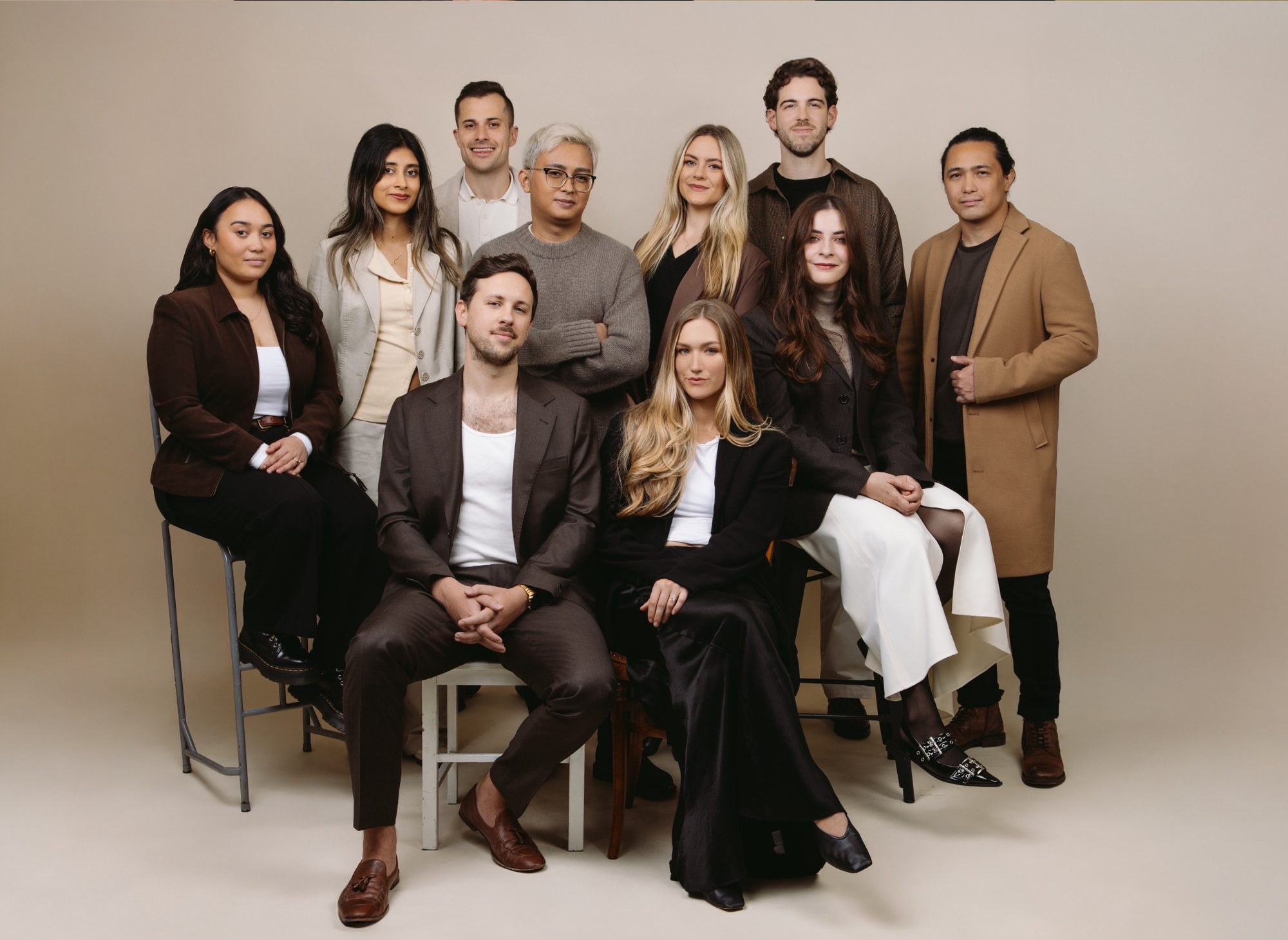 House of Psalm full team portrait in studio setting, dressed in neutral tones